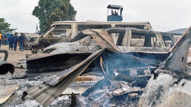 Burned vehicles are seen at the front gate of the Makala prison after it was attacked by supporters of jailed Christian sect leader Ne Muanda Nsemi in Kinshasa, Democratic Republic of the Congo