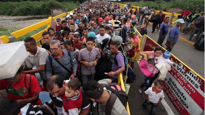 Venezuelanos cruzando a fronteira da Venezuela com a Colômbia