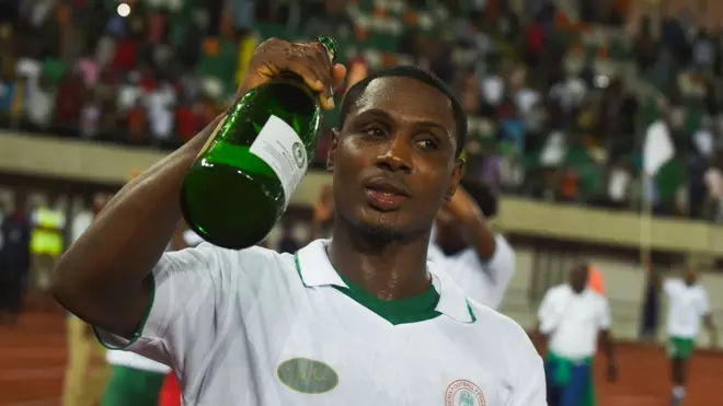 Nigerian footballer Odion Ighalo dey drink champagne to celebrate World Cup 2018 qualifying match between Nigeria and Zambia; taxes wey Nigeria dey plan fit affect how people dey drink champagne.