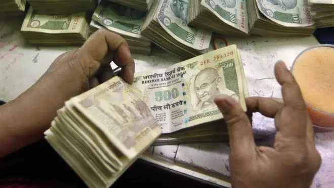 Indian currency at a cash counter inside a bank in Calcutta in June 2012