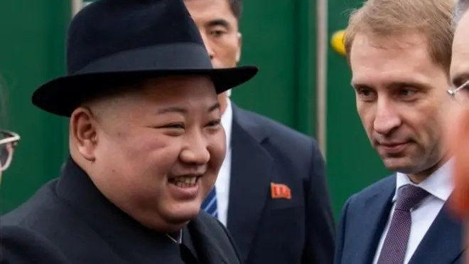 North Korean leader Kim Jong Un takes part in a welcoming ceremony at a railway station in the far eastern settlement of Khasan
