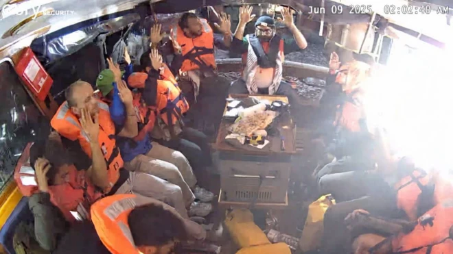 A photo purportedly showing activists with their hands up on board the Madleen ship