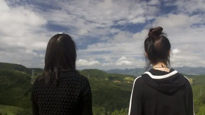 Now safely over the border Mira (L) and Jiyun (R) look back towards China