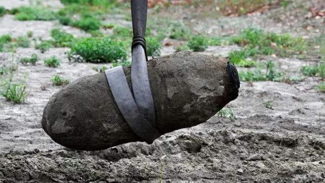 The unexploded bomb is removed from the river bed