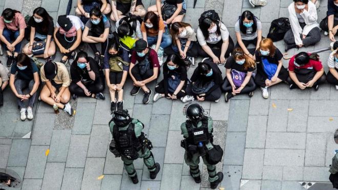 Riot police detain a group of people during a protest in the Causeway Bay district of Hong Kong