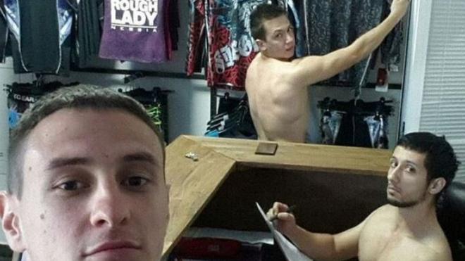 Naked workers in closthes shop
