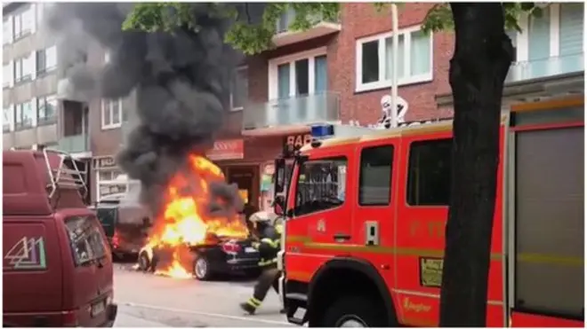 Burning car and fire engine