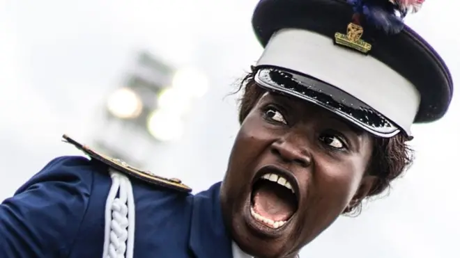 A Nigerian policewoman gives an order as she marches in front of authorities and members of the public during a Democracy Day parade on May 29, 2017 in Freedom Square in Owerri. Democracy Day celebrates the end of military rules in Nigeria in May of 1999.