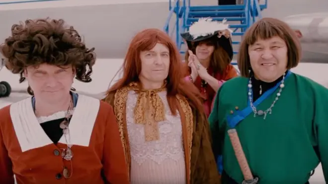 В клипе региональные чиновники выходят из самолета в женской одежде