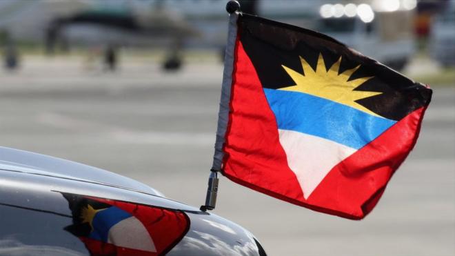 An Antigua and Barbuda flag on a car