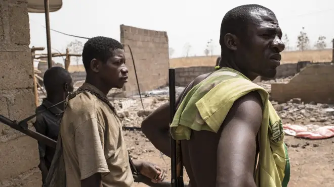 Vigilante people for Bakin Kogi, Kaduna state, northwest Nigeria dey look di damage after herdsmen attack di village on 24 February, 2017