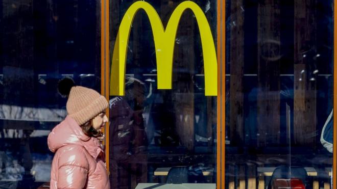 A woman walks past a McDonald's restaurant in Moscow in March 2022