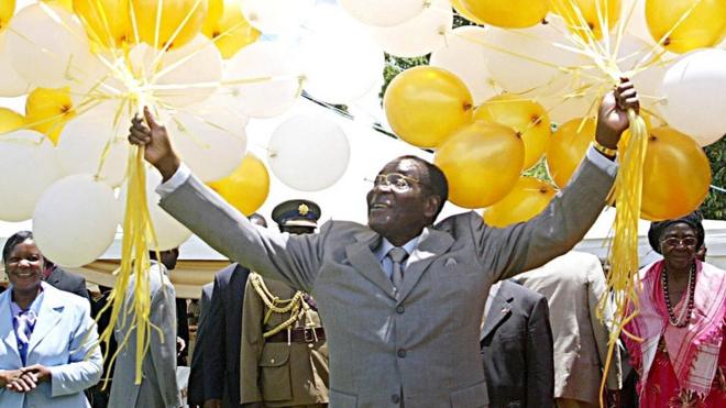 Zimbabwe's veteran leader Robert Mugabe holds 83 balloons in front of relatives and friends at his official residence in Harare, Zimbabwe - 21 February 2007