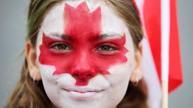 Clara Swain looks on with a painted face as she participates in the East York Toronto Canada Day parade, as the country marks its 150th anniversary with "Canada 150" celebrations, in Toronto, Ontario,