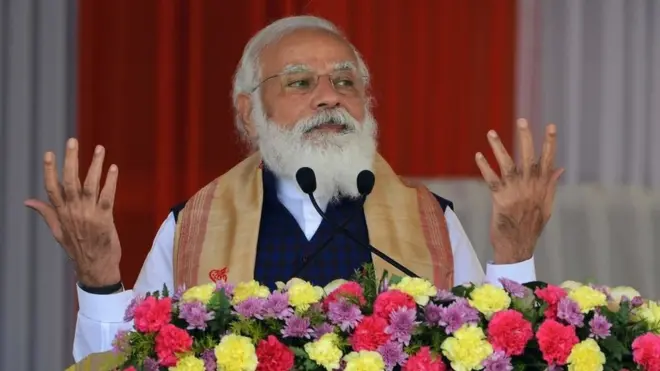 Prime Minister Narendra Modi gestures as he addresses a public meeting at Jerenga Pathar in Sivasagar district of India's Assam state on January 23, 2021.