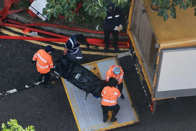 mergency responders load a body onto a vehicle at the scene of the Tai Po apartment fire in Hong Kong, China, 28 November 2025.
