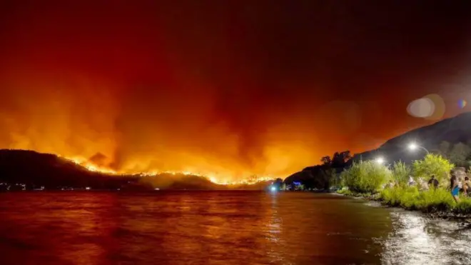 lago com incêndio ao fundo