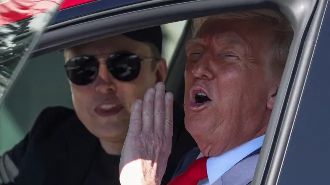 Donald Trump and Elon Musk sit in a car