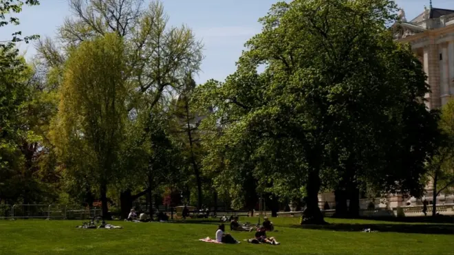 People sit in a park in Vienna