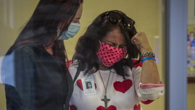 美國加利福尼亞州富勒頓（Fullerton, California）一家醫院內一位醫生（左）在安慰一名新冠肺炎患者妻子（15/2/2021）