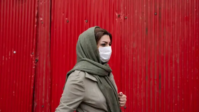 An Iranian woman wearing a protective face mask
