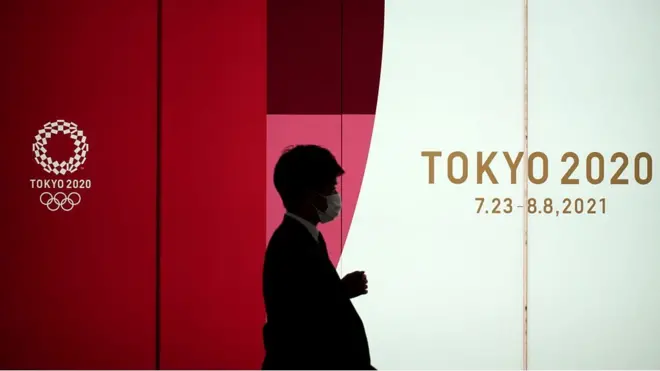 路过东京夏季奥运灯牌的日本民众