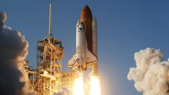 The launch of the space shuttle Discovery on a mission to the International Space Station