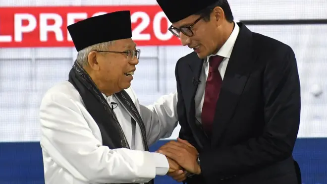 Cawapres nomor urut 01 K.H. Ma'ruf Amin (kiri) berjabat tangan dengan Cawapres nomor urut 02 Sandiaga Uno (kanan) saat mengikuti Debat Capres Putaran Ketiga di Hotel Sultan, Jakarta, Minggu (17/3/2019).