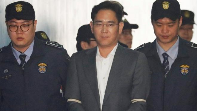 Mr Lee arrives at court in Seoul, South Korea, flanked by police officers and wearing handcuffs. April 7, 2017.