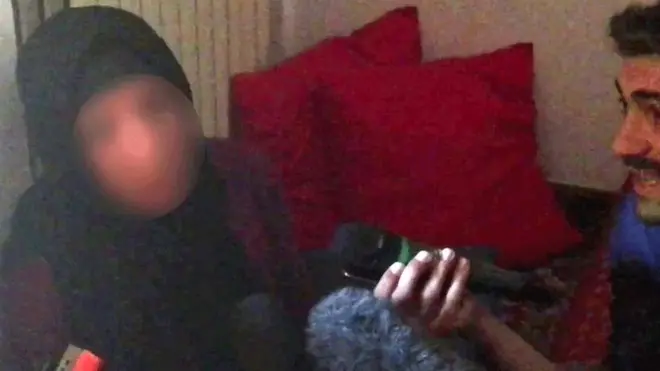 Valeria Collina Kadhija talks to reporters (her face has been blurred)