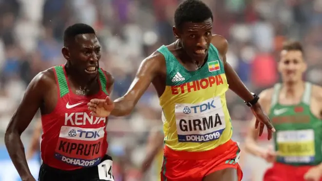 Kenya's Conseslus Kipruto crosses the finish line to win gold ahead of silver medallist Ethiopia's Lamecha Girma