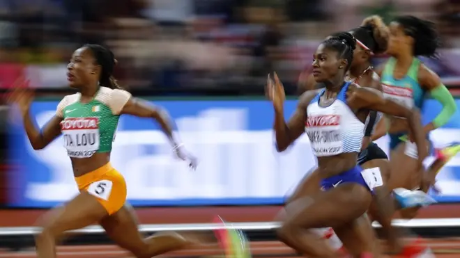 Women"s 200 Metres Semi-Final - London Stadium, London, Britain â€“ August 10, 2017. Marie-Josee Ta Lou of Ivory Coast wins the heat ahead of Dina Asher-Smith of Great Britain