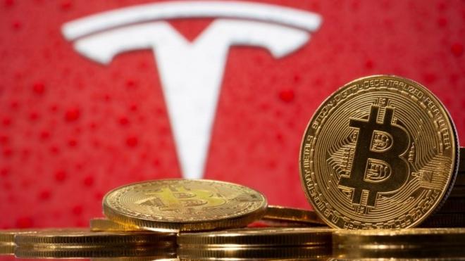 FILE PHOTO: Representations of virtual currency Bitcoin are seen in front of Tesla logo in this illustration taken, February 9, 2021.
