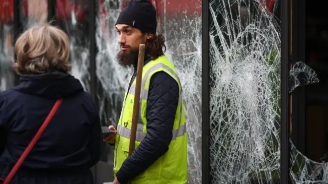 A man takes part in the Paris clean-up after the 8 December protests in Paris
