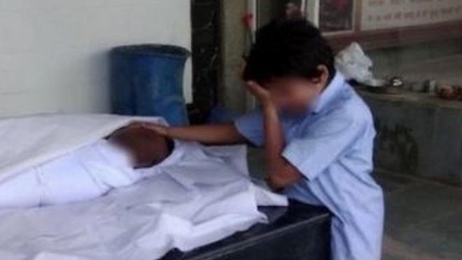 This photo of the worker's 11-year-old son sobbing next to his body went viral.