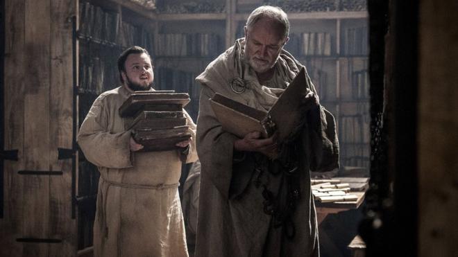 A still from the television series Game of Thrones showing two characters in a library