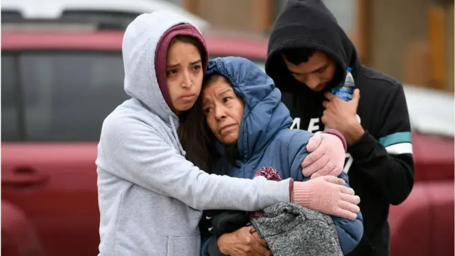 Family members mourn the six deaths at a birthday party shooting in a mobile home in Colorado Springs, Colorado