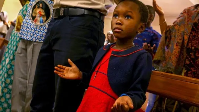 Girl praying in church
