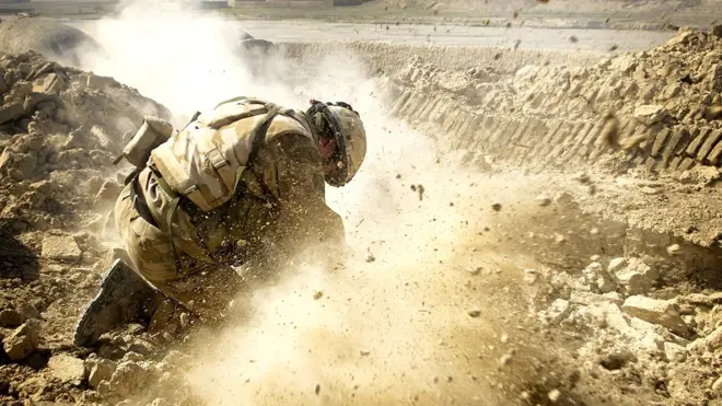 British soldier firing light mortars in to an Afghan village, January 2007