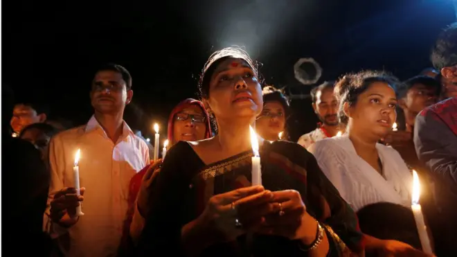 People in Dhaka have held candelit vigils for the 20 victims of the attack