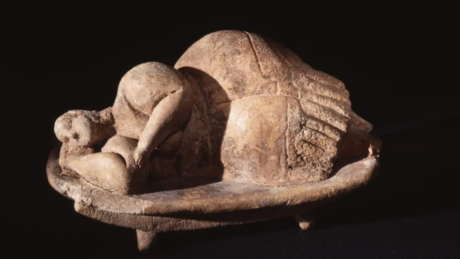 Clay figurine excavated in Malta, depicting a woman sleeping peacefully on her side.