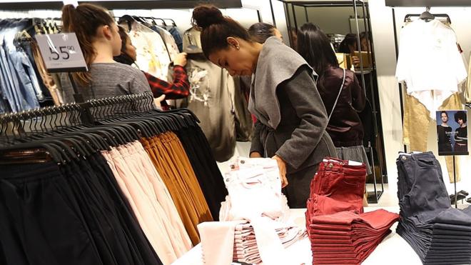 Customers shop for clothing following the opening of a Zara store