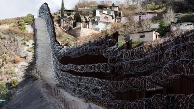 A border wall divides Nogales, Arizona from the Mexican state of Sonora