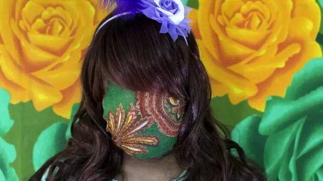 Bangladeshi woman with face covered by green fabric