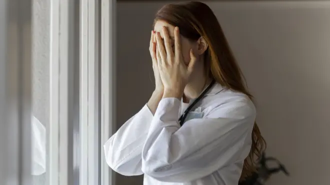 Woman with her head in hands