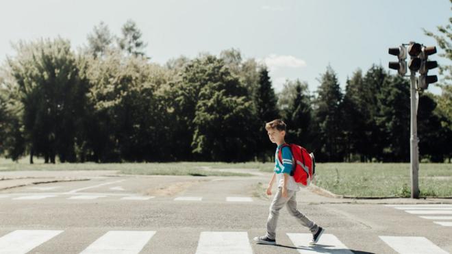 a boy walking to school