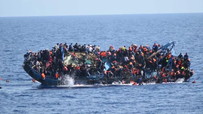 Migrants cling to a capsizing boat in the Mediterranean, 25 May