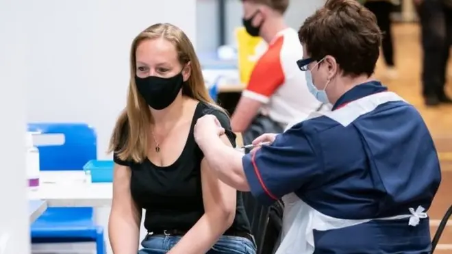 Practice Nurse Nicola Morris (Right) vaccinates Lisa Hanson with the Pfizer Covid-19 vaccination, at a mass coronavirus vaccination centre at Adwick Leisure Centre, in Doncaster,