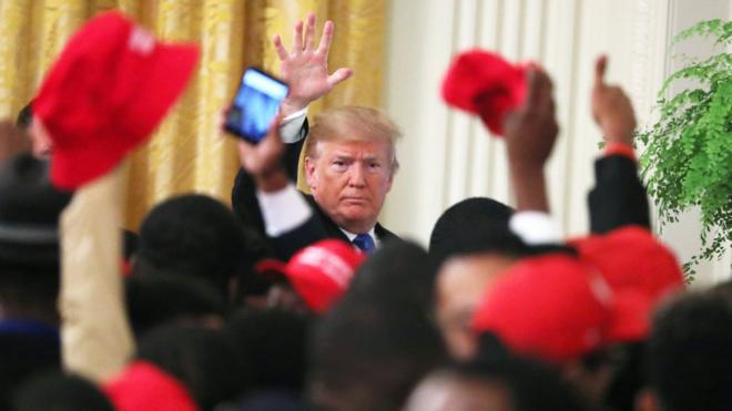 Trump waves to a crowd of young black conservative activists