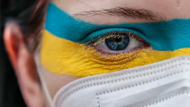 Face painted with Ukraine colours